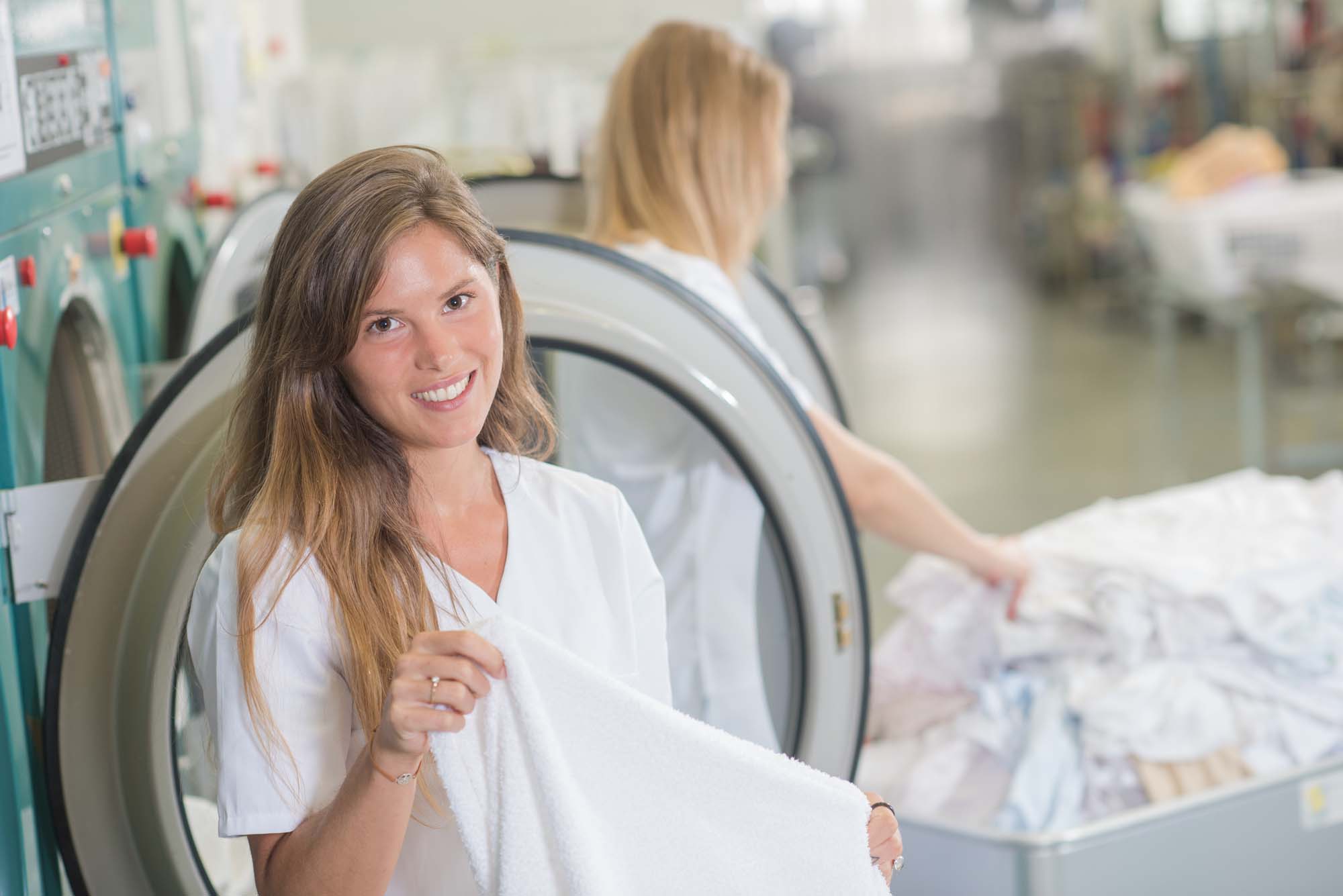 Women working in professional launderette