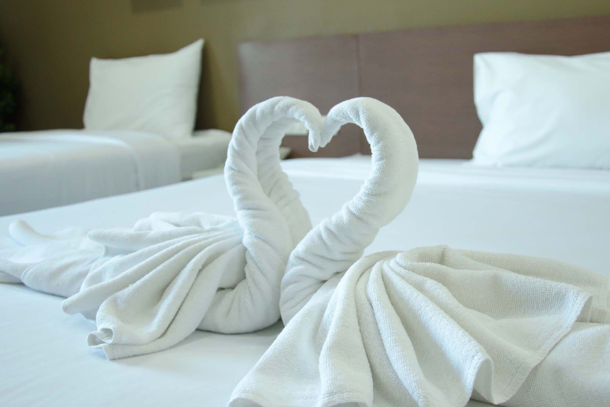 Swan towel on bed